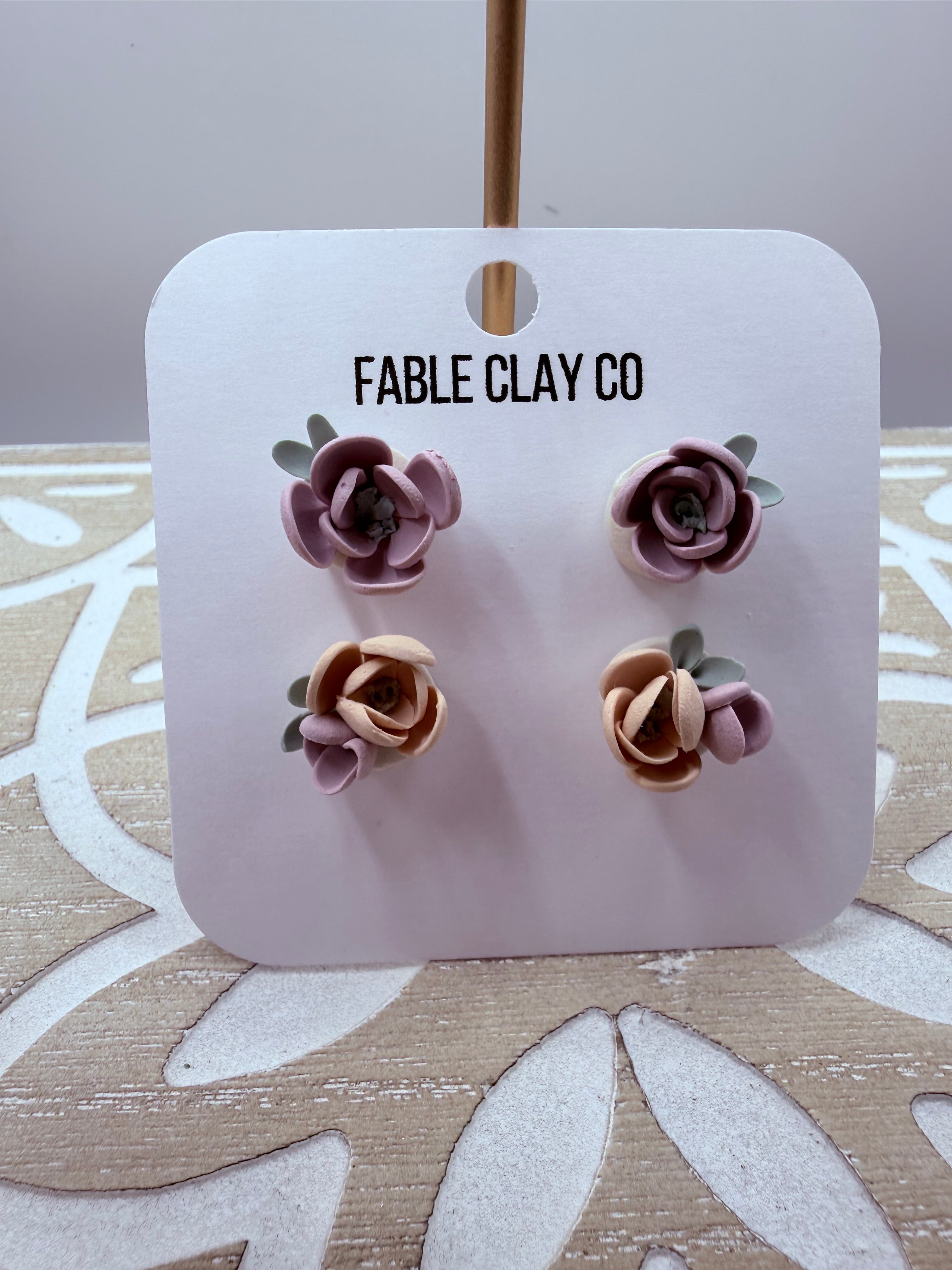 Fable Clay Co floral arrangement with colorful ceramic flowers in a decorative vase, showcasing vibrant and detailed floral art.