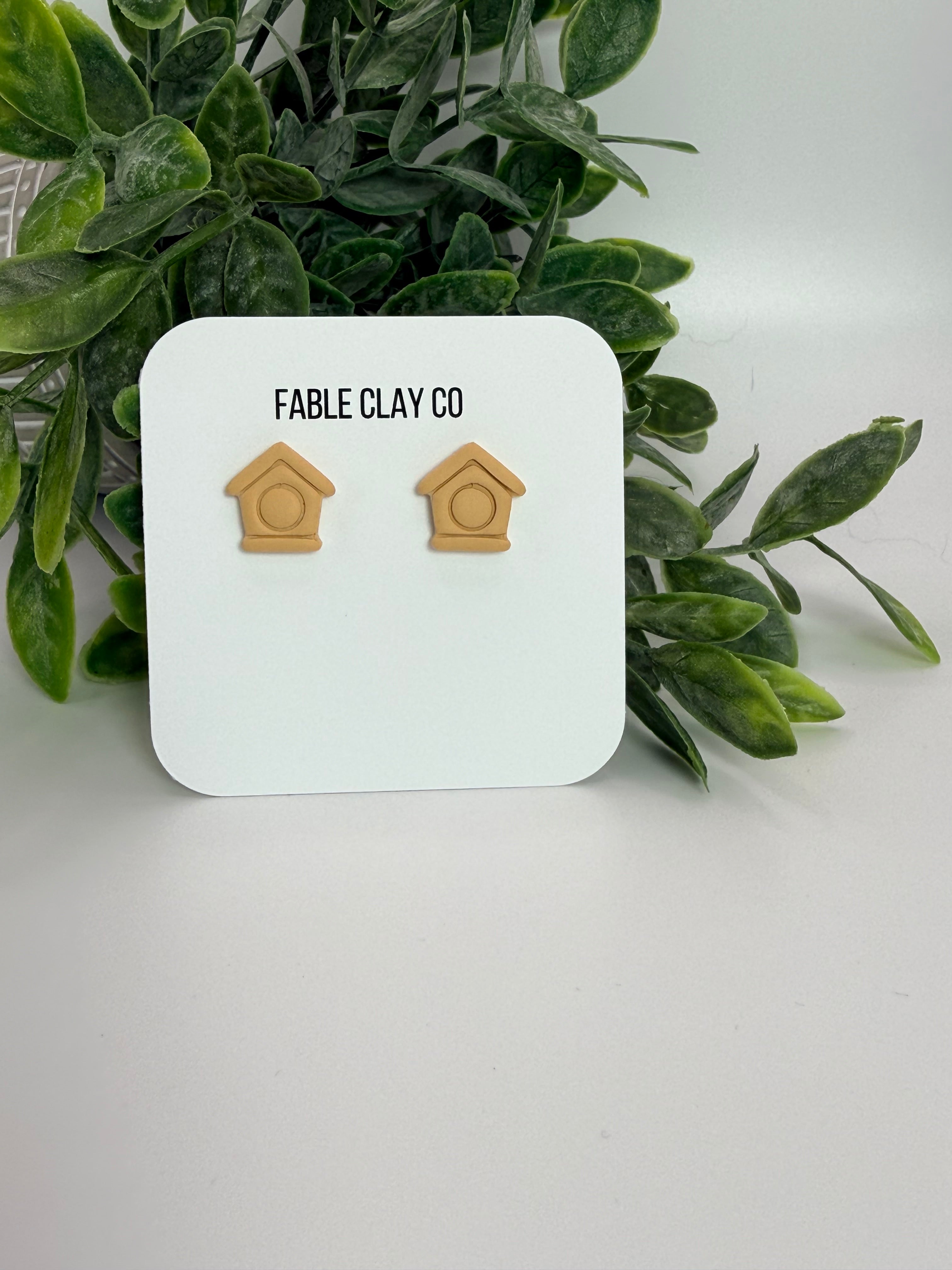 Fable Clay Co bird house with a rustic wooden design, featuring a small entry hole and natural finish for outdoor bird habitat.