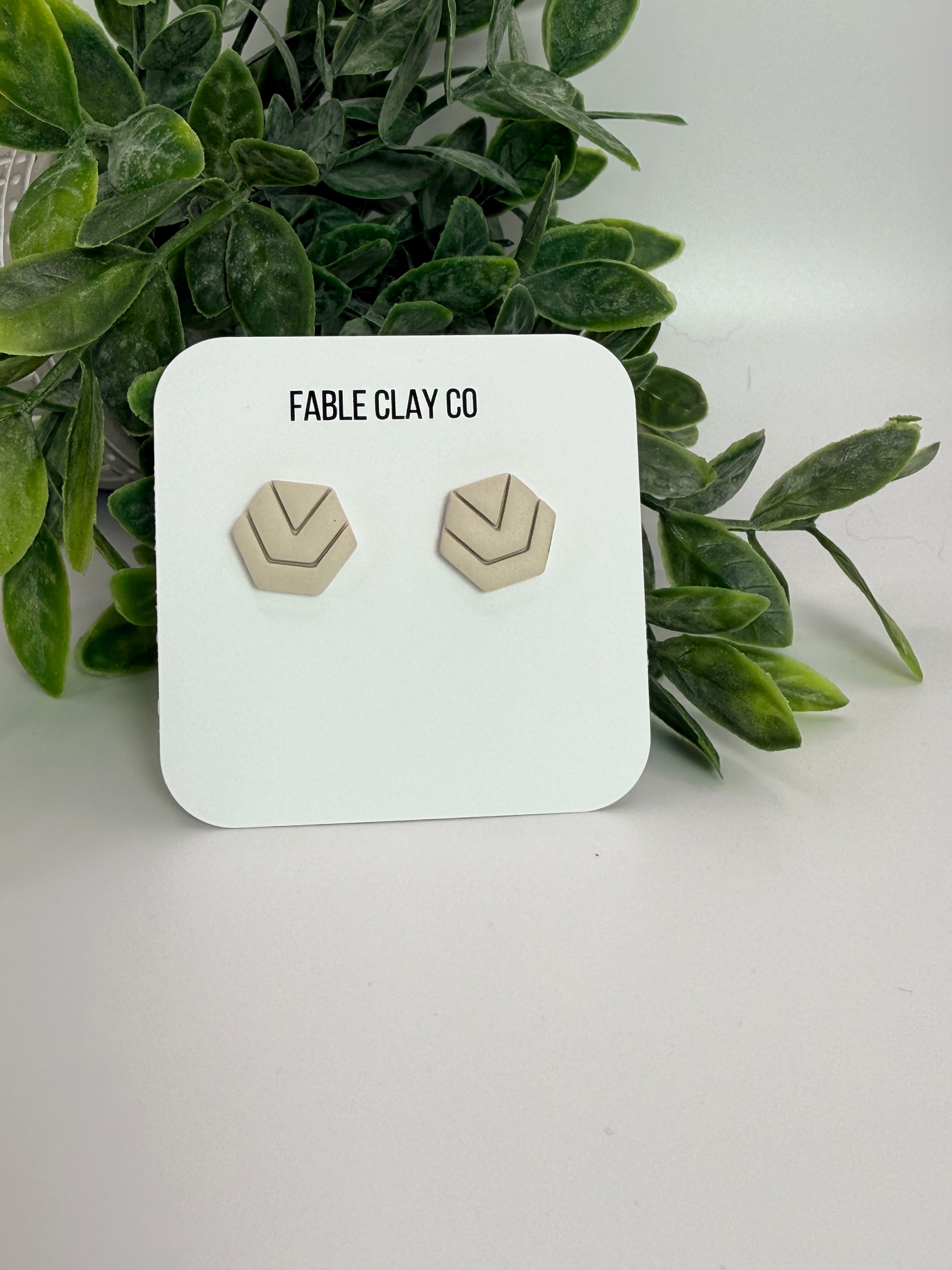 Fable Clay Co Hexa ceramic sculpture with geometric design in earthy tones displayed on a wooden surface.