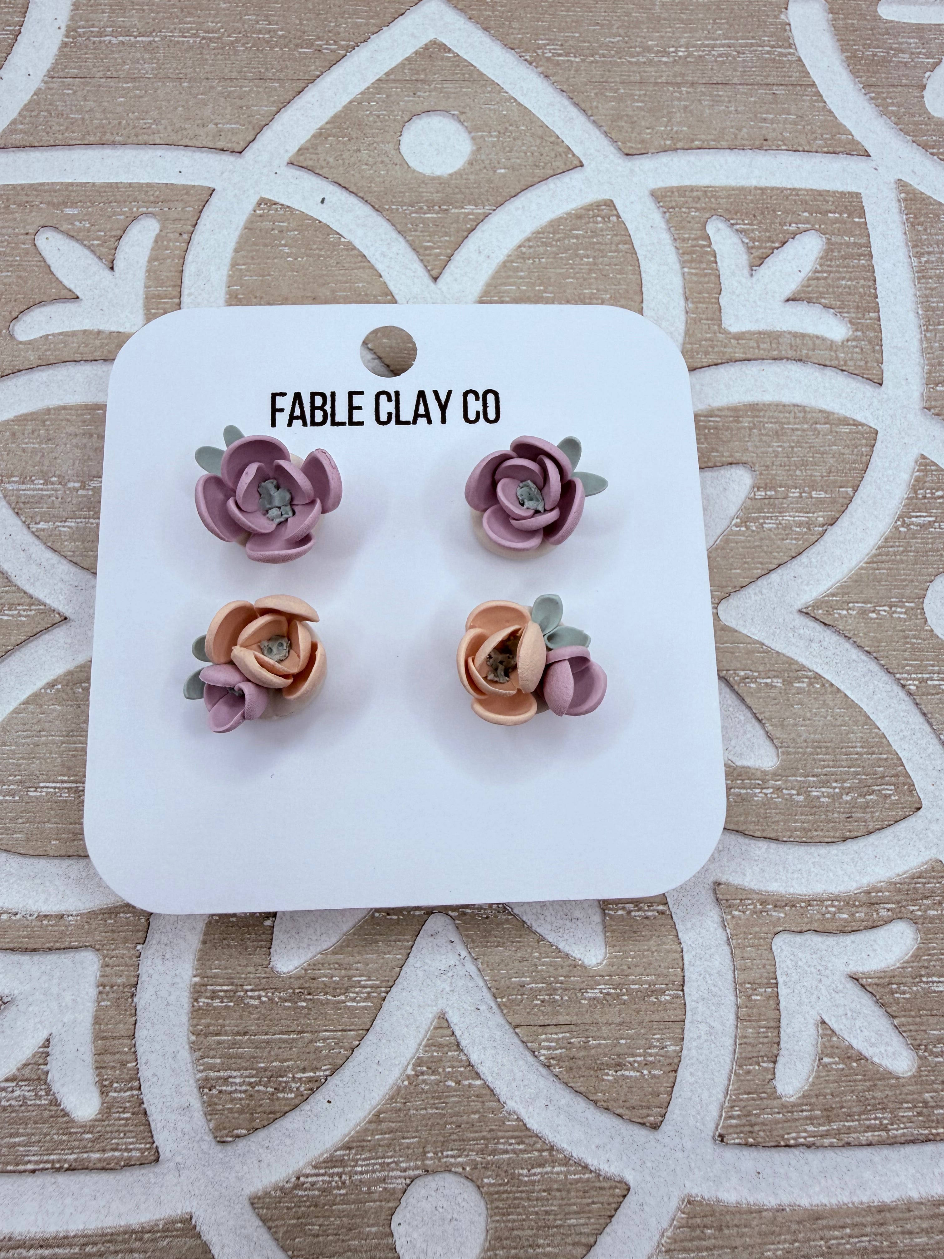 Colorful floral arrangement featuring vibrant faux flowers from Fable Clay Co, displayed in a decorative container.