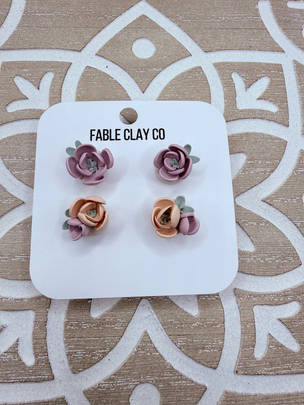 Colorful floral arrangement by Fable Clay Co, featuring vibrant clay flowers in a decorative display.