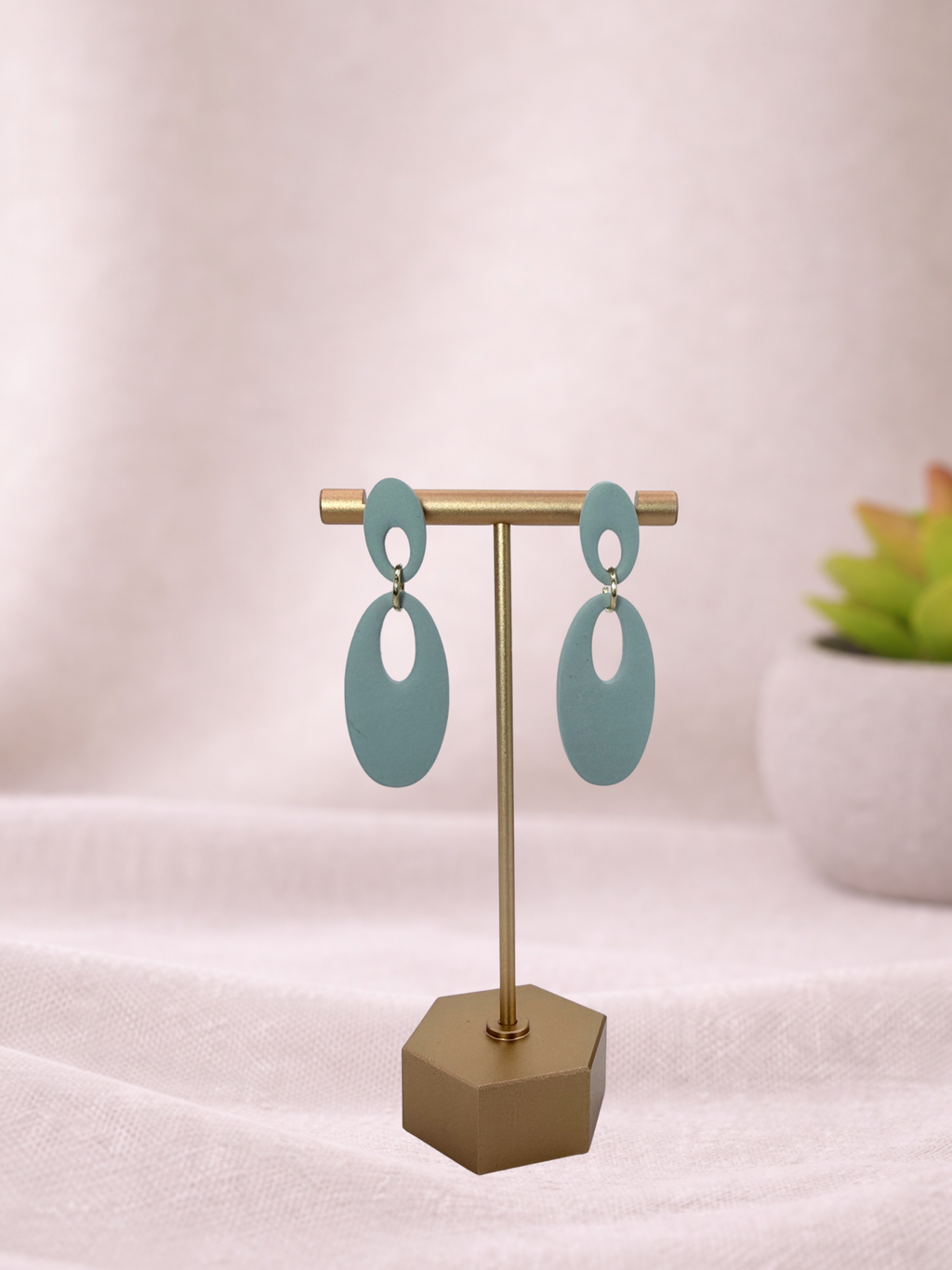 Fable Clay Co Reese minimal oval drop earrings in earthy clay with sleek, modern design hanging from silver hooks.