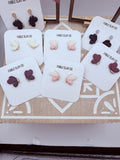 Lightweight handmade butterfly earrings by Fable Clay Co, made of colorful polymer clay with detailed wing designs.