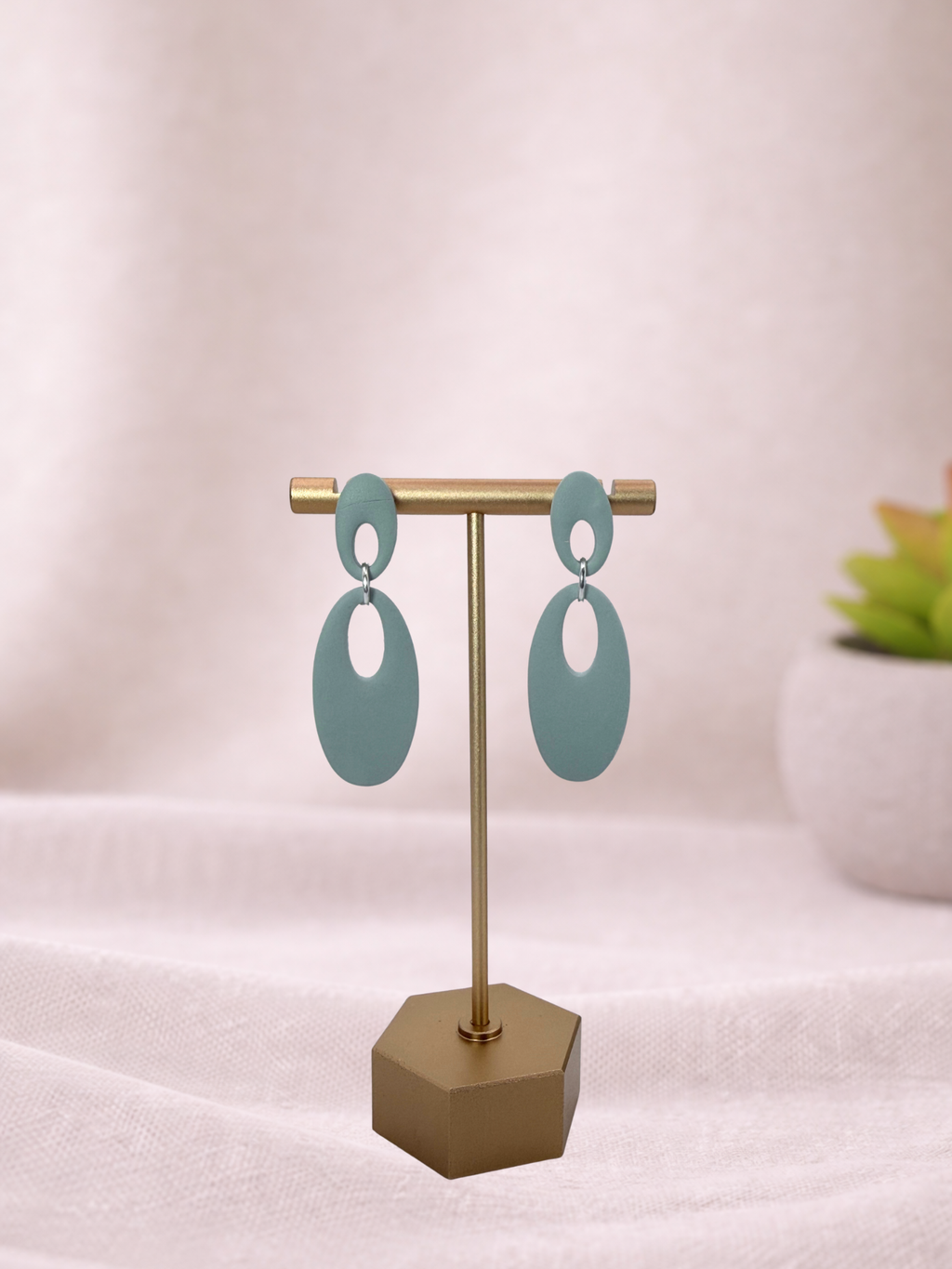 Fable Clay Co Reese minimal oval drop earrings in warm clay tones, showcasing sleek, modern jewelry design.
