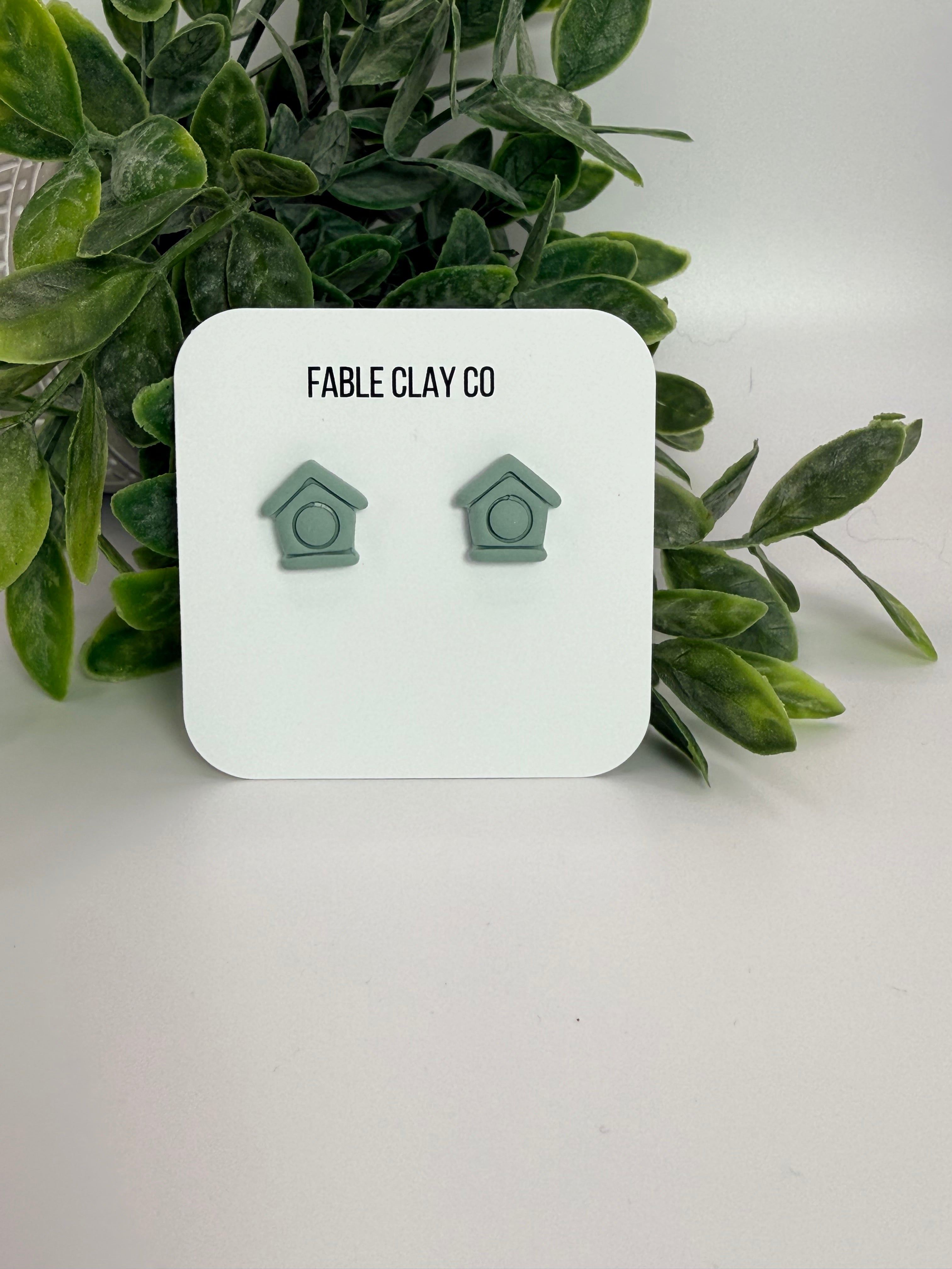 Rustic clay bird house by Fable Clay Co with a natural finish and small entry hole, designed for garden or outdoor use.