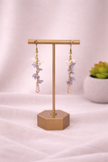 Lilac Cascade Earrings by Fable Clay Co featuring hanging clay earrings with a soft purple floral design.