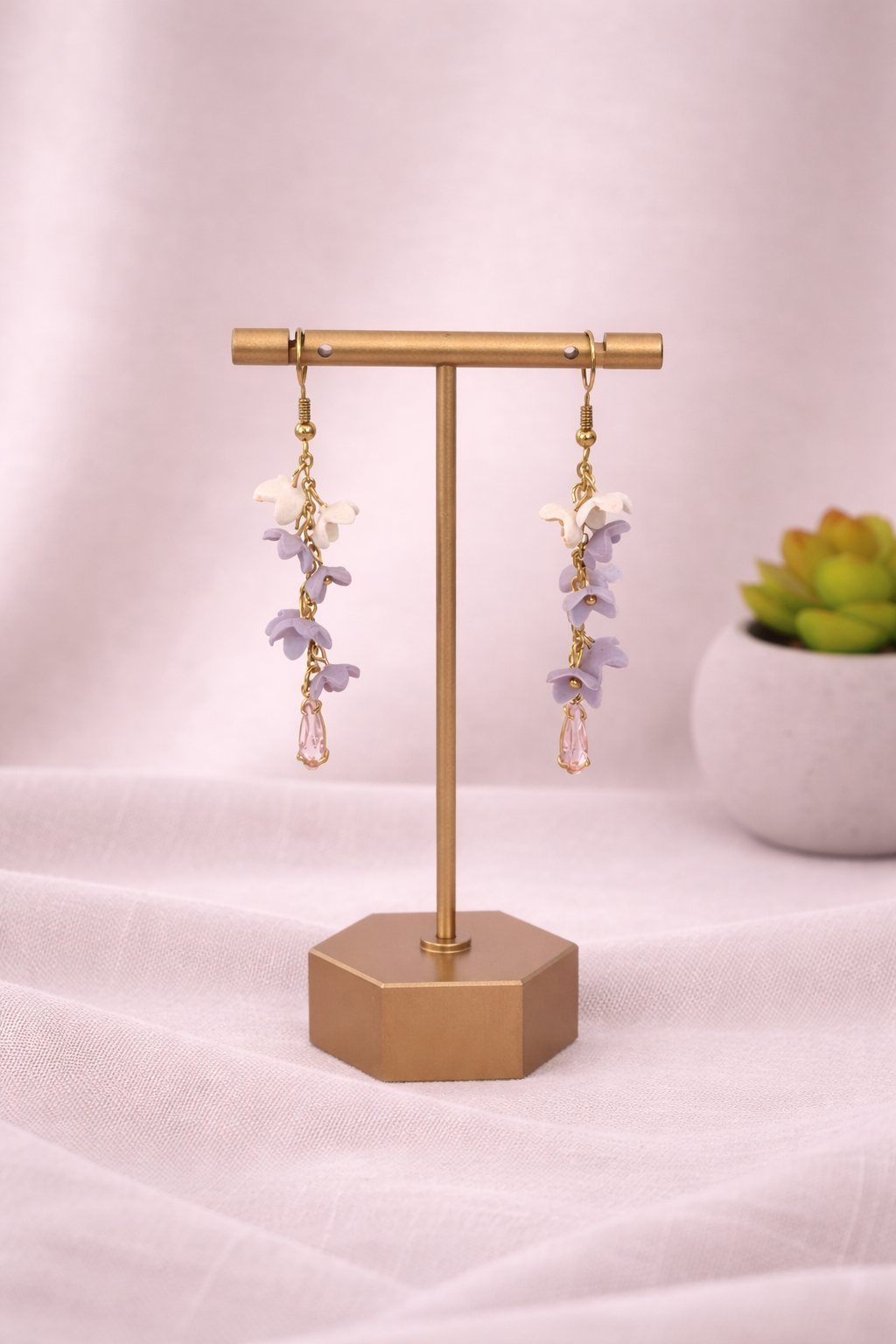 Lilac Cascade Earrings by Fable Clay Co featuring hanging clay earrings with a soft purple floral design.