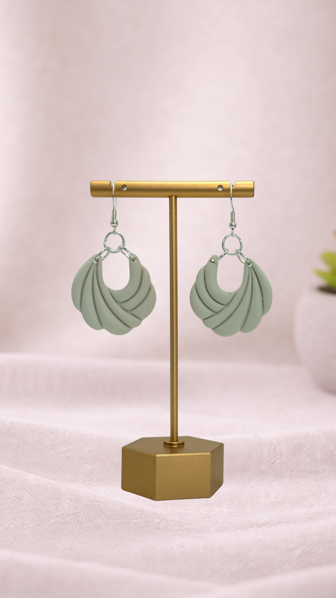 Fable Clay Co Arlow Spring Vault ceramic vase with textured green glaze and rounded shape on a neutral background.