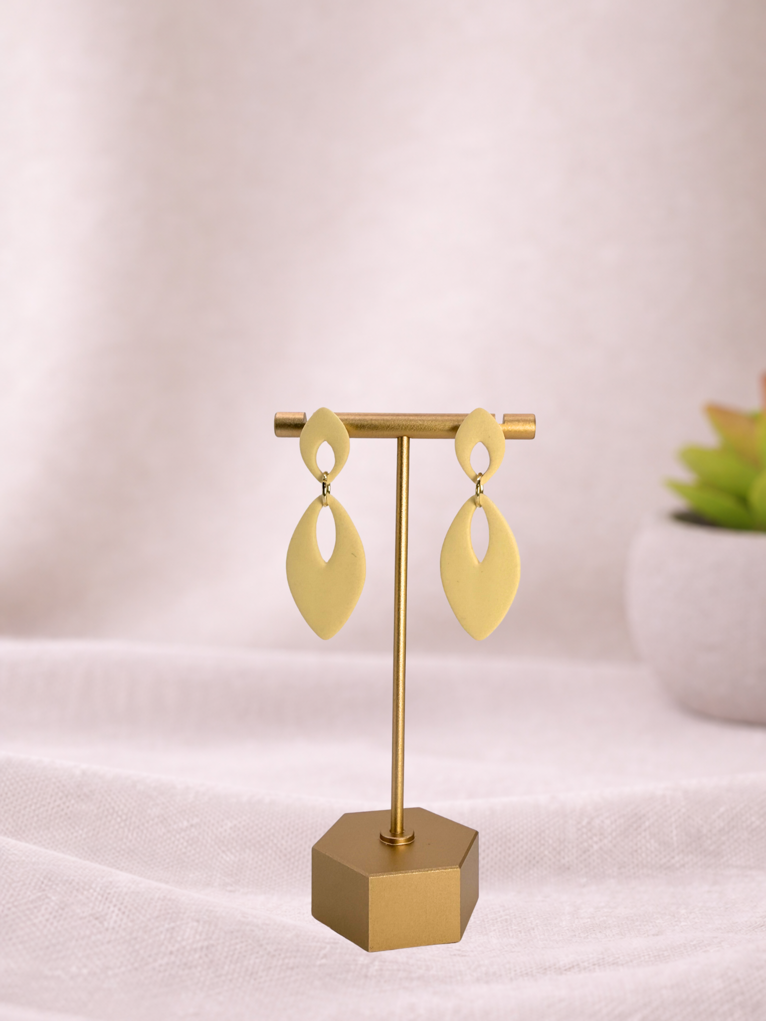 Fable Clay Co Eloise Spring Vault ceramic vase with textured surface and pastel green glaze, placed on a wooden surface.