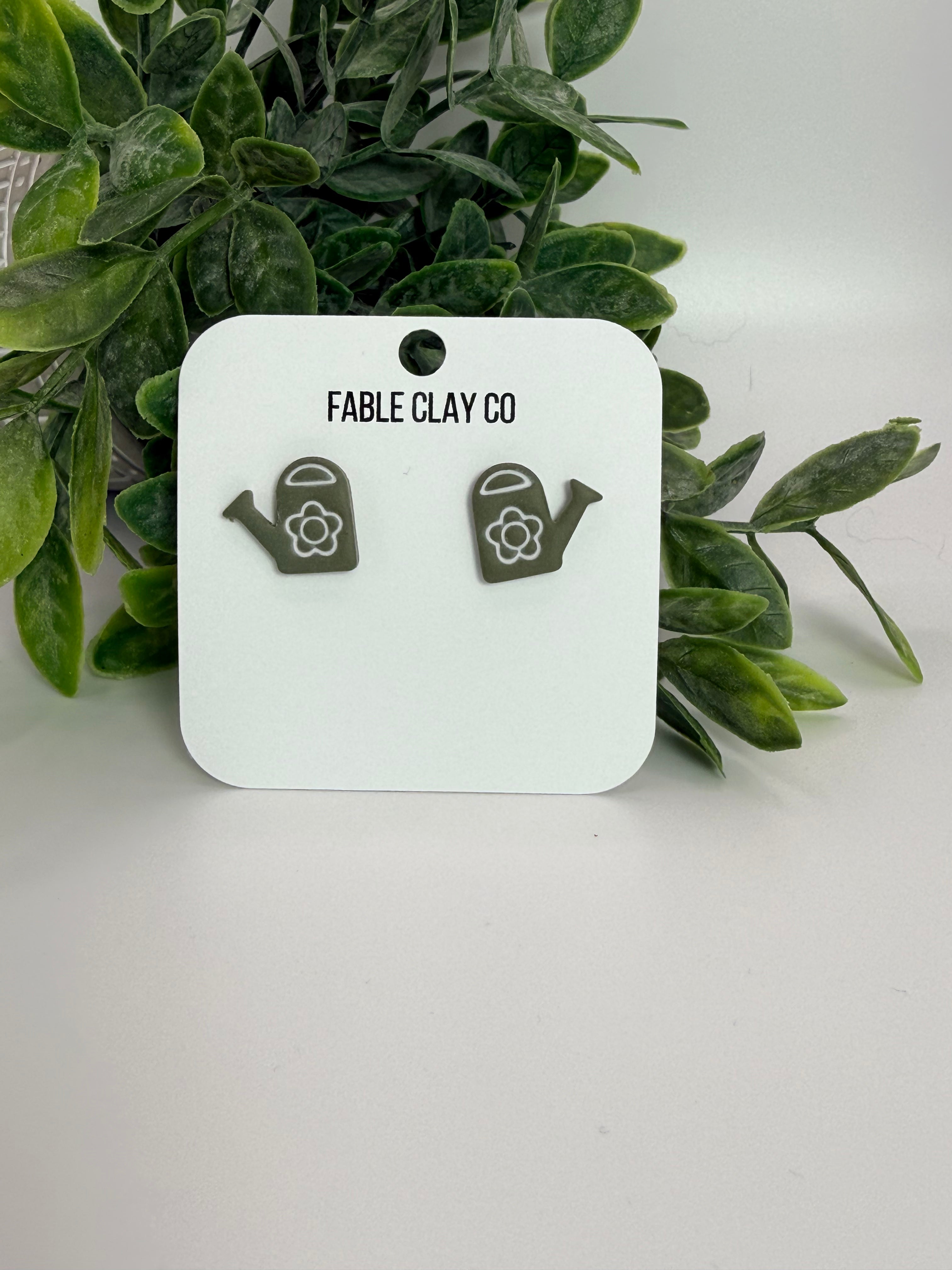Fable Clay Co water can with a rustic design and metal handle, suitable for garden or decorative use.
