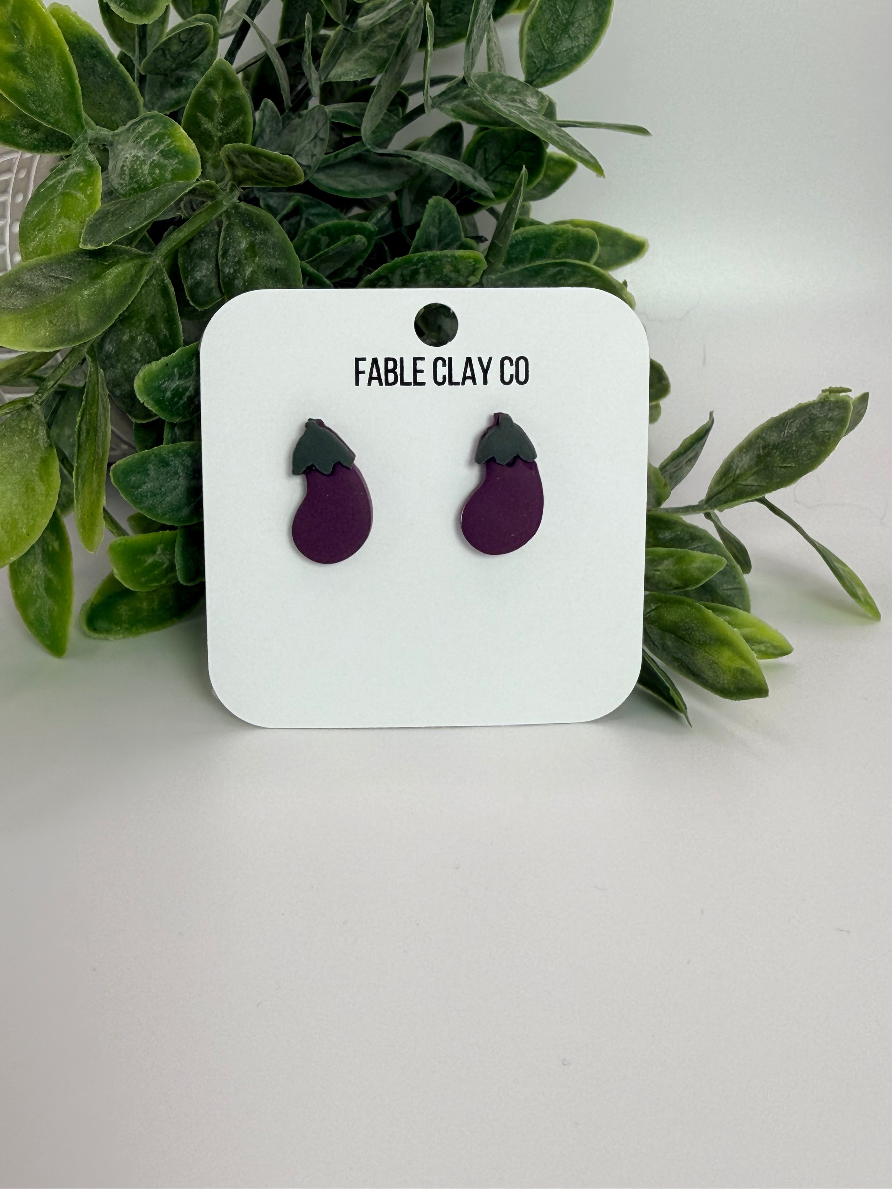 Fable Clay Co eggplant ceramic sculpture with realistic purple and green glazed details on a neutral background.