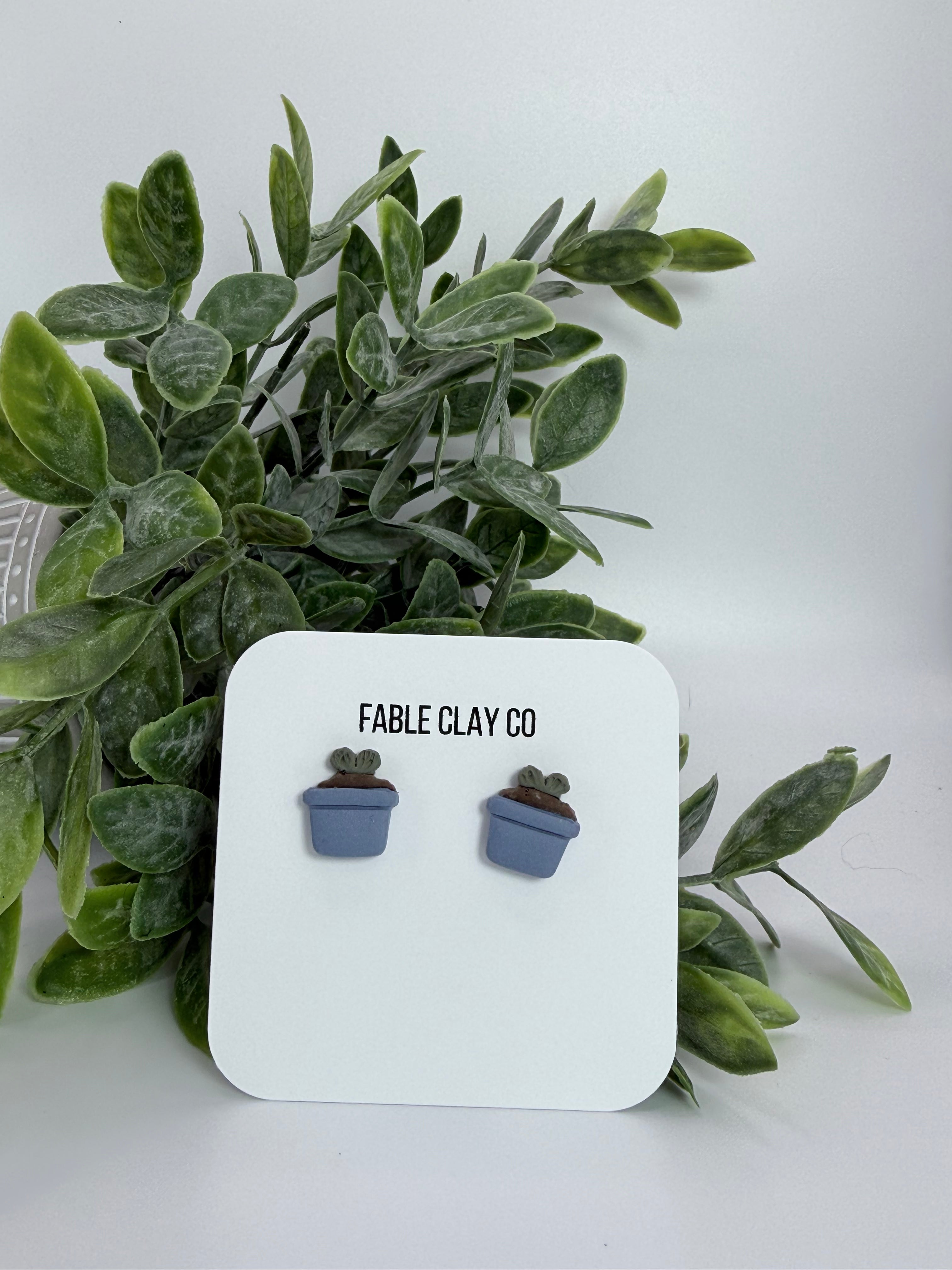Fable Clay Co Sprout ceramic planter with a small green plant, showcasing a modern, minimalist design on a white background.